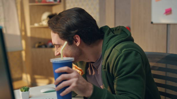 istock Laughing freelancers eating pizza having fun at office. Smiling guys lunch break 1735401878