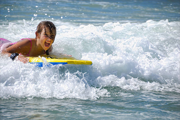 istock Summertime - Girl Catching a Wave at the Beach 173540241