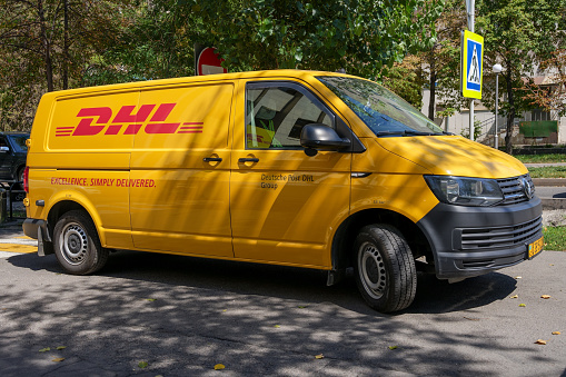 Almaty, Kazakhstan - August 25, 2023: A Volkswagen Transporter car from the DHL company in the parking lot. International delivery