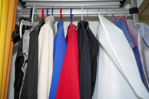 istock Wardrobe overflowing and colorfully mixed with jackets and pants, sweaters 1735405631