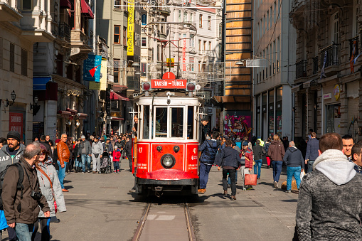 Turkey, Istanbul, April 9, 2023, the old tram drives through a crowd along Istiklal Street towards Taksim Square. icon of Istanbul