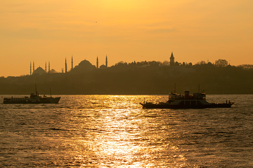 Istanbul Silhouette and sunset over the ferry.