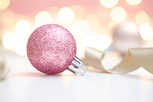 Pink Christmast ball on shiny background.