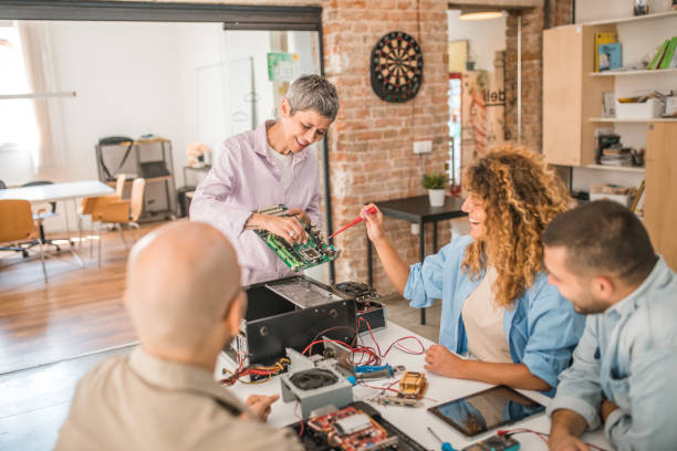 istock A smiling teacher teaches a group of students a lesson about computer parts and hardware 1735408847