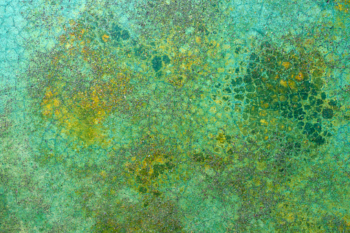 Metal rusty surface with corrosion spots, with feeling green paint