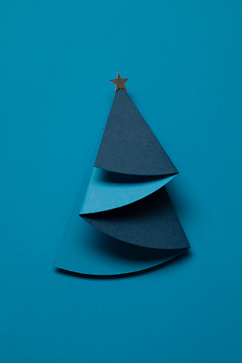 Paper Christmas tree, blue background.