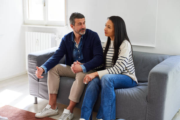 istock Couple sitting on sofa at marriage counseling office 1735412653