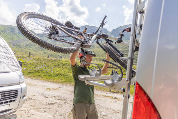 istock Mountain biker loads bike on camper van 1735412723