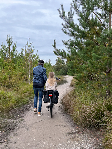 Grandfather with his Toddler Granddaughter  making a trip on e-bike in the heath area cold Brunssummerheide.