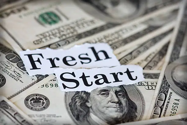 Photo of Dollar notes with fresh start text on top