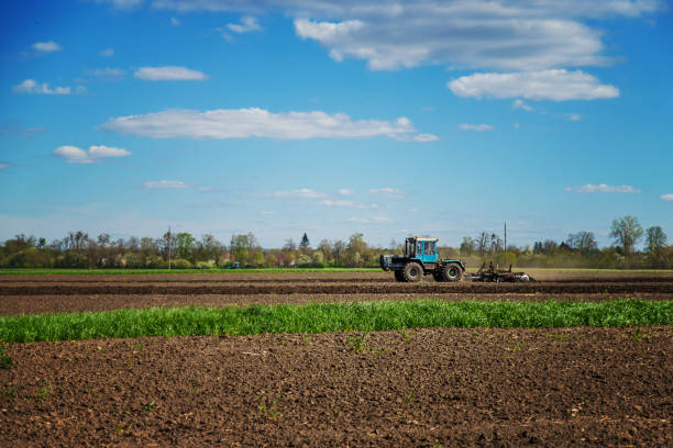 istock The tractor plows the soil in the field. Selective focus. 1735413927