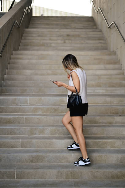 istock hipster girl model walking up the staircase. 1735414189