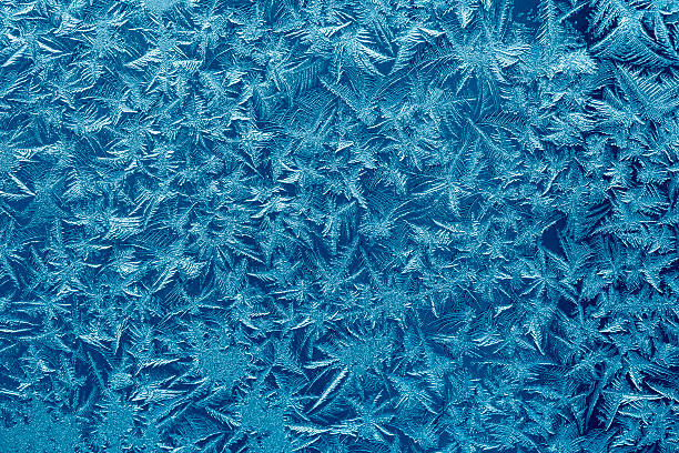 Frosty pattern Beautiful frost pattern on a window. ice crystal blue frozen cold stock pictures, royalty-free photos & images