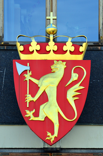 Oslo, Norway: national emblem - The state arms of Norway date from the early Middle ages, the current version was introduced in 1905 when King Haakon VII became king of Norway and modernized in 1992 - yellow crowned standing lion bearing a golden crown and holding a silver and yellow axe on a red shield, crown with orb and cross.
