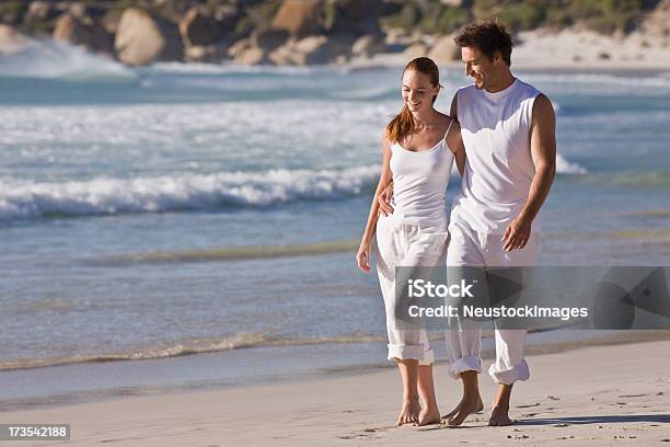 Romantic Young Couple Walking Together On Beach Stock Photo - Download Image Now - Beautiful People, Casual Clothing, Day