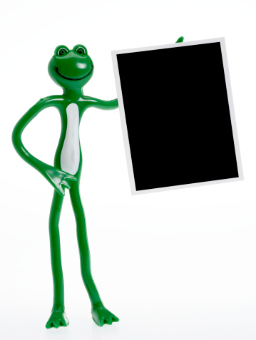 Frog presenting blank picture frame with clipping path