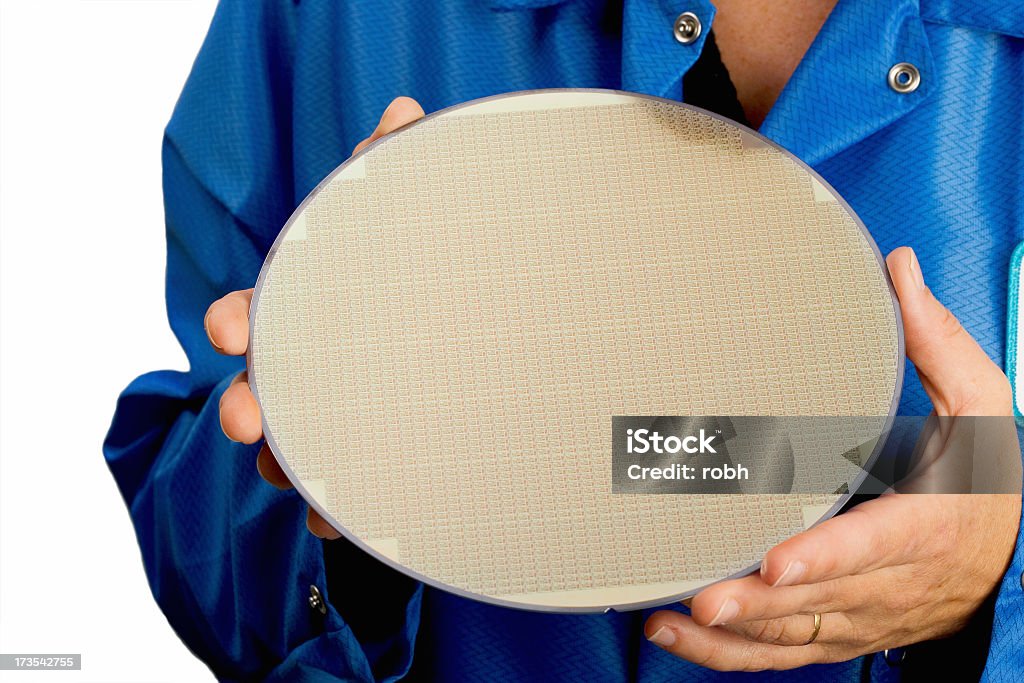Person in blue holding a large silicone wafer Woman holding processed silicon wafer. Computer Wafer Stock Photo