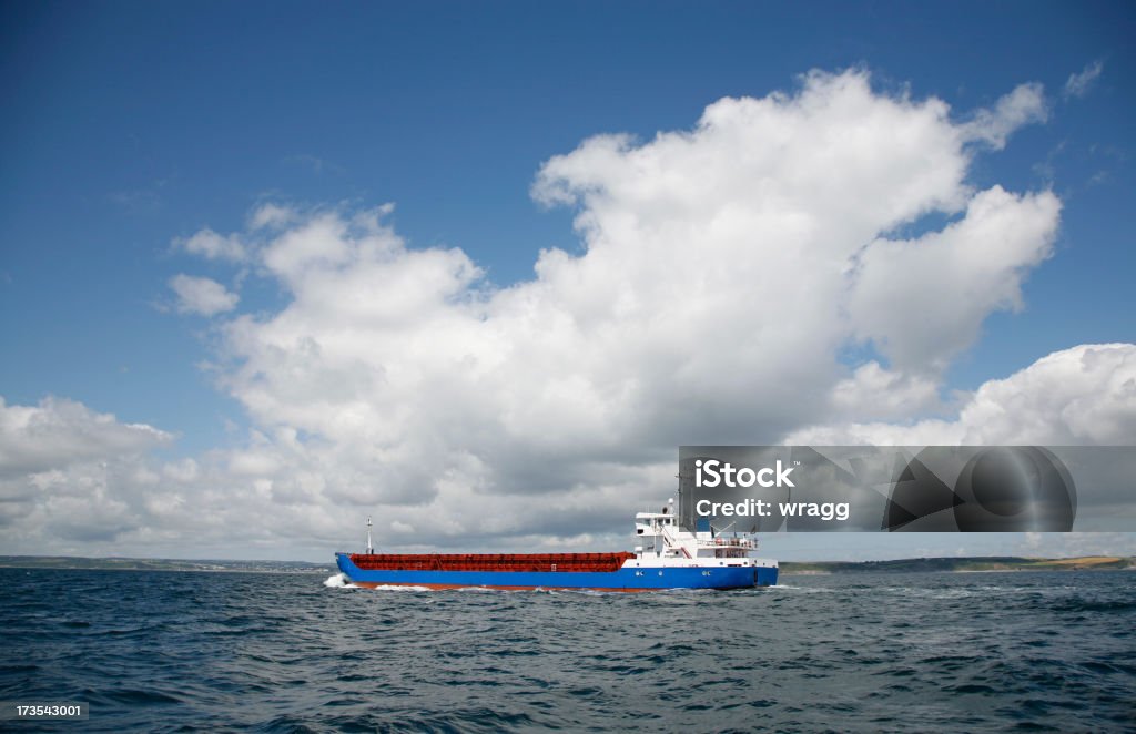 Working at Sea Coastal cargo ship steaming towards port. Business Stock Photo