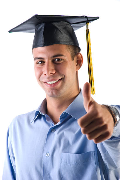 Graduate student Smiling graduate student with thumb up standing proud isolated on white. georgijevic stock pictures, royalty-free photos & images