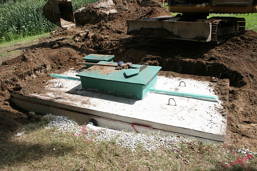 Septic system construction with concrete wastewater reservoir.