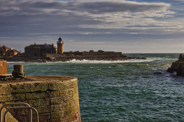 istock Rough sea waves crashing around harbour wall and lighthouse, Port Patrick, Dumfries and Galloway, Scotland, Britain 1735446961
