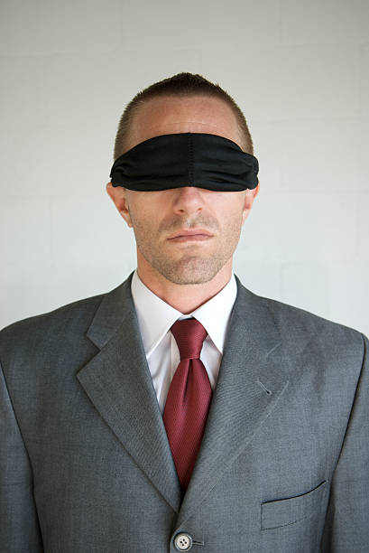 istock Serious Blindfolded Businessman Stands Against White Background 173544724