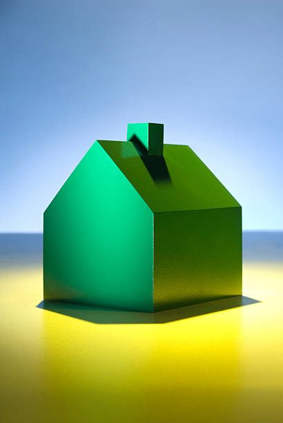 Green model house with blue sky. stock photo