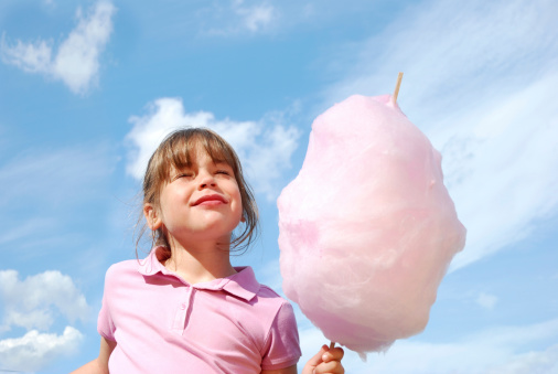 Girl holding cotton candy.Being a Kid Lightbox