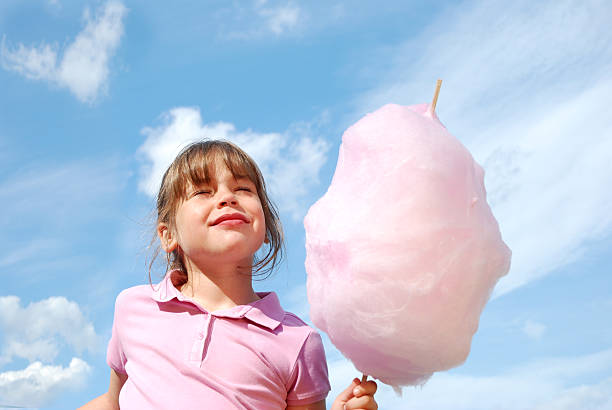 Ecstatic Girl holding cotton candy.Being a Kid Lightbox child cotton candy stock pictures, royalty-free photos & images