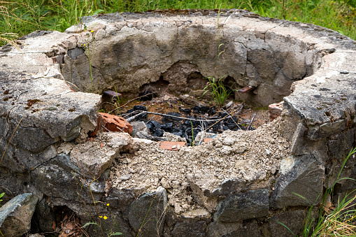 an old campfire site made of stones in the summer