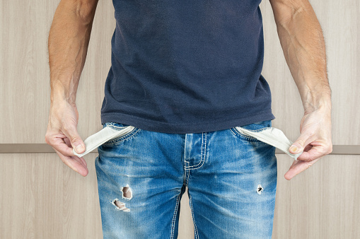 Man in casual clothes showing his empty pockets
