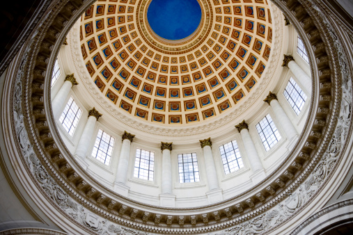 Ceiling of a building with a large dome.