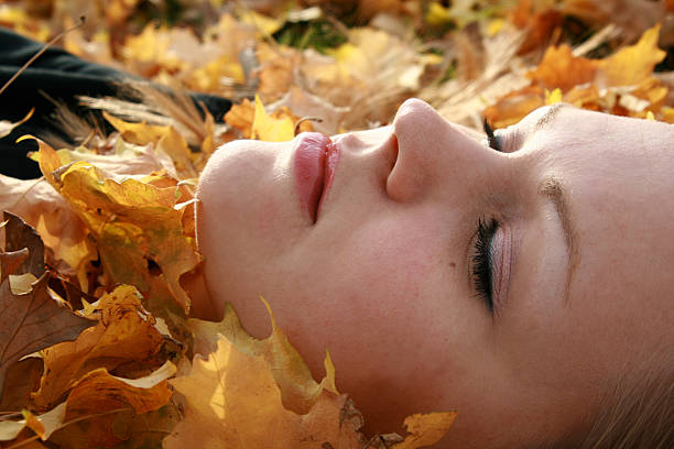 istock Woman Lying in Autumn Leaves 173545376
