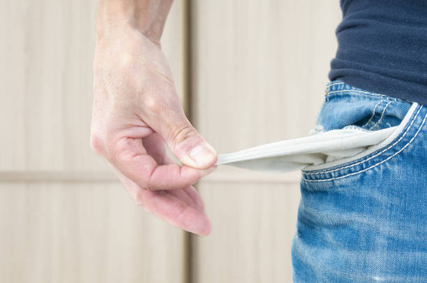 istock Man in casual clothes showing his empty pockets 1735454095