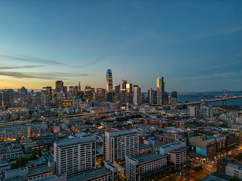 Aerial view of San Francisco skyline at sunset with the Bay Bridge.