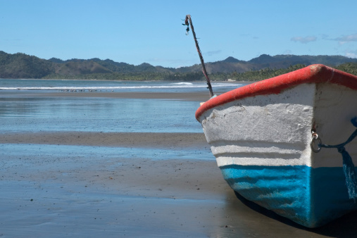 Local market fishermen beach their boats during heat of the day in Costa Rica