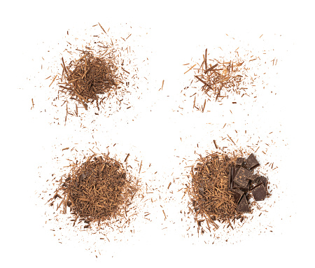 Grated chocolate pile isolated. Crushed chocolate shavings, crumbs, flakes heap, cocoa sprinkles for desserts decoration on white background top view