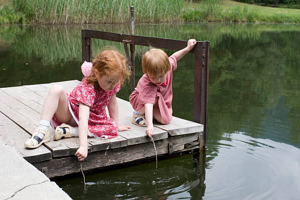 istock Young girls at lake, making waves 173547621
