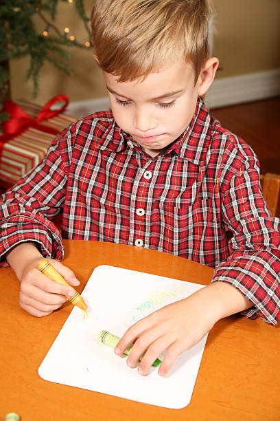 istock Young Blonde Boy Coloring With Crayons On Christmas 173547931