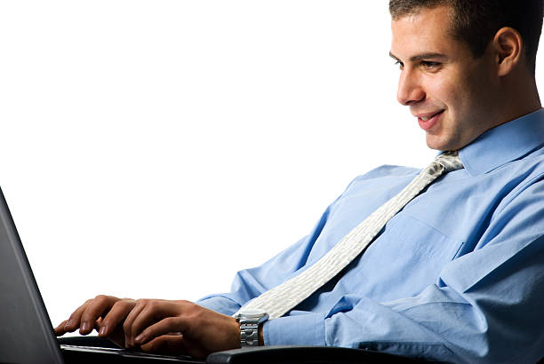 Businessman Smiling businessman in blue shirt and tie, sitting in chair and working on laptop. He is isolated on white. georgijevic stock pictures, royalty-free photos & images