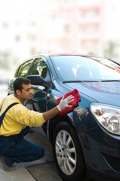 istock Man washing and detailing a sedan by hand 173548481