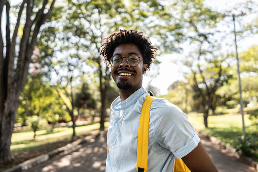 Portrait of a young man at university campus outdoors