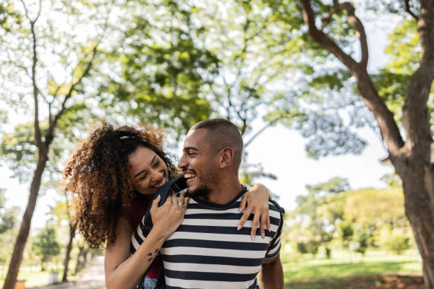 istock Young couple doing piggyback at a park 1735494173