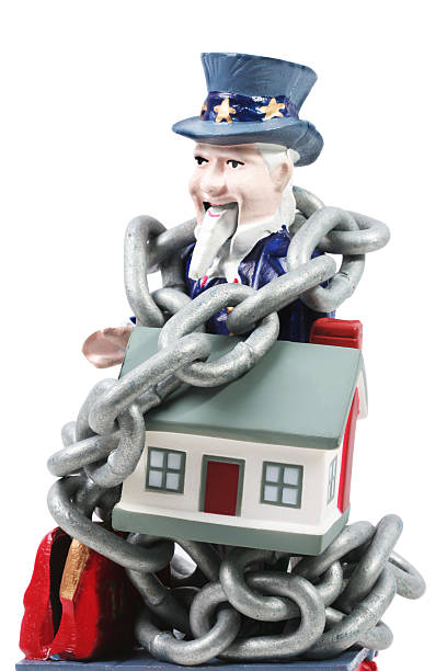 Housing bubble Uncle sam with chains and home. This is an old cast iron Uncle sam mechanical bank. uncle sam broke stock pictures, royalty-free photos & images