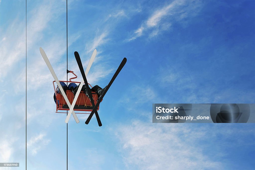 two skiers on a chairlift two skiers on a chairlift as seen from below Ski Lift Stock Photo