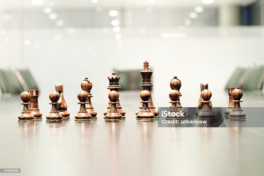 Corporate strategy 4 Chess pieces in a boardroom Aggression Stock Photo