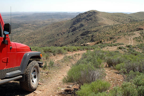 A red 4x4 vehicle driving in the Flinders Ranges stock photo