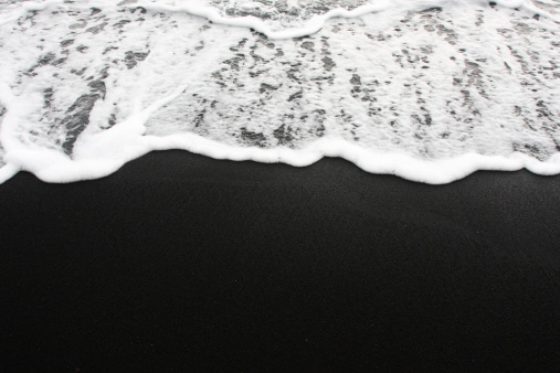 Foamy waves wash up onto a black sand beach in Hawaii. Check out my other Beach Scenes here