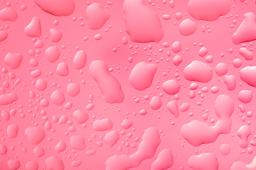 Water drops on pink luminous background for background