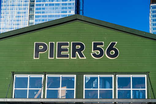 Seattle WA, USA - September 20, 2023:  The Pier 56 building is brightly lit during the sunset.